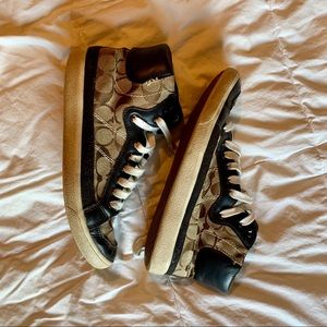 Brown and tan Coach high top shoes.